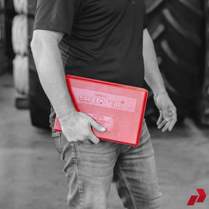 Person carrying the Safety Seal Deluxe Truck Kit case