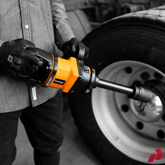 Impulse air impact wrench beside a case of impact sockets