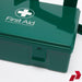 Green first aid box with a cross symbol on a white background