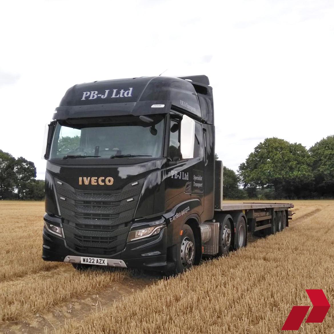 Iveco S/X Way Stainless Steel Mirror Guard on a black lorry in a straw field