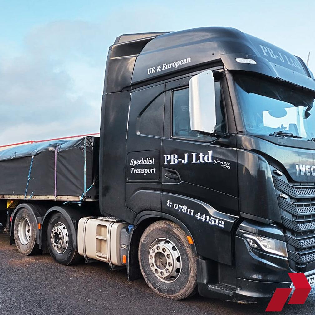 Iveco S/X Way Stainless Steel Mirror Guard on a black lorry on a tarmac road