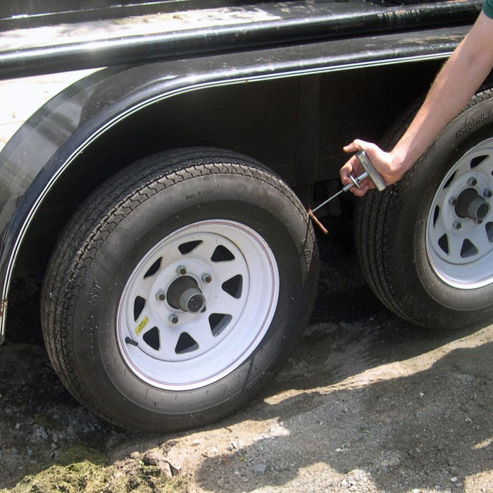 Fitting a Safety Seal repair plug into an off-road tyre using an insertion tool