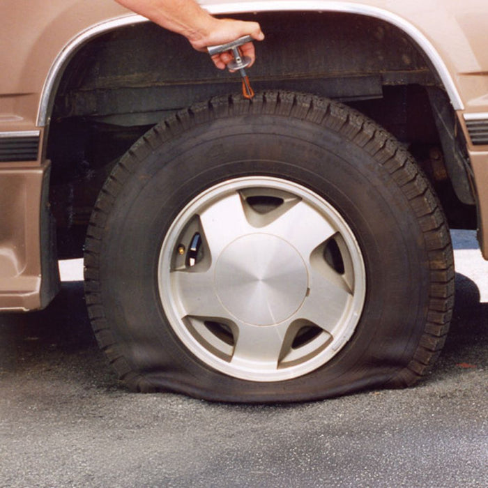 Flat tyre on a vehicle before repair