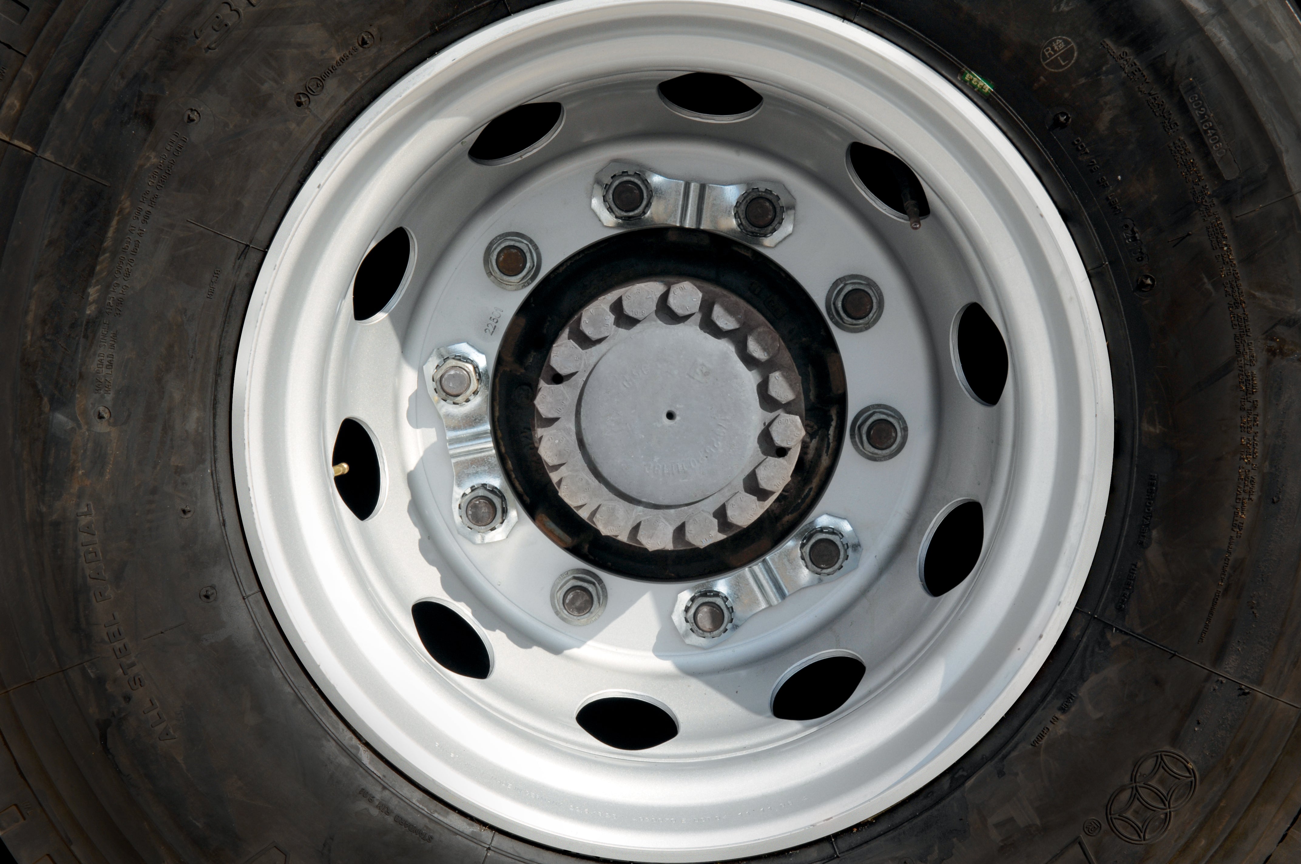 Showing a wheel with three prolock devices attached to the wheel nuts. they're silver on colour so look very unobtrusive to the wheel.