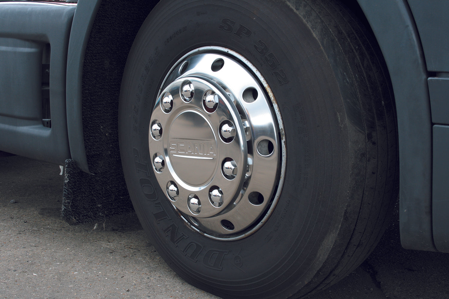 large commercial wheel, with the centre having a new nut ring applied. it's shiny, mirror-like silver finish fits well.
