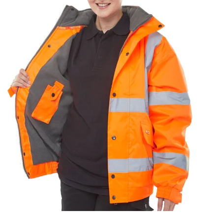An image of a woman showing off a thick, high vis orange coat. You can't see the whole of the woman's face, just her smile. She opens half of it to reveal a grey fleece inside, and inside pocket. The other side remains closed to show the poppers, pockets and reflective strips.