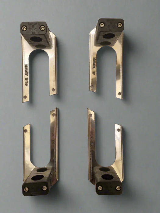 Four metallic brackets on a gray background